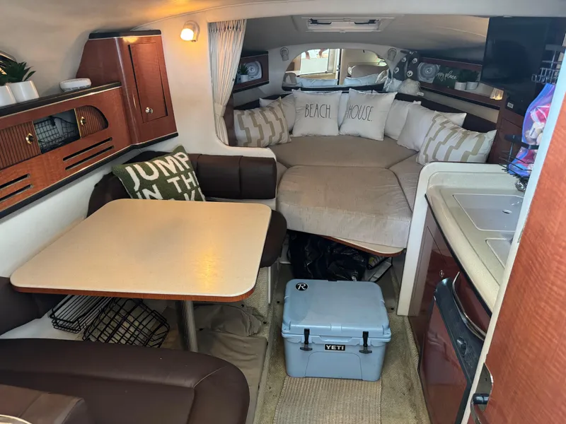 Slide: The Image of Interior of 2003 Sea Ray 280 Sundancer with cozy seating and kitchenette. - 9