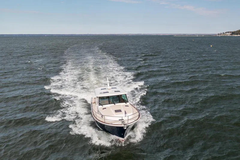 Slide: The Image of 2025 Sabre 43 Salon Express cruising on open water, leaving a wake behind. - 10