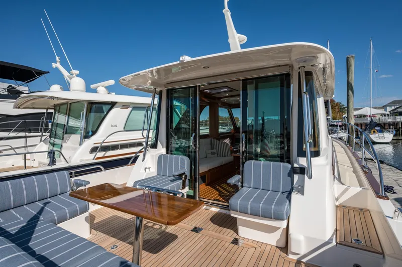 Slide: The Image of 2025 Sabre 43 Salon Express yacht with elegant seating and wooden deck. - 19