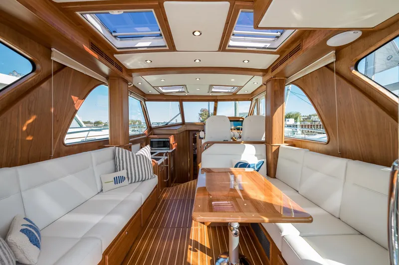 Slide: The Image of Luxurious interior of 2025 Sabre 43 Salon Express yacht with elegant wood finish and plush seating. - 24