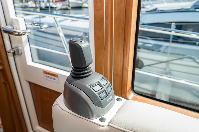 Slide: The Image of Joystick control in 2025 Sabre 43 Salon Express yacht interior, near window and door. - 32