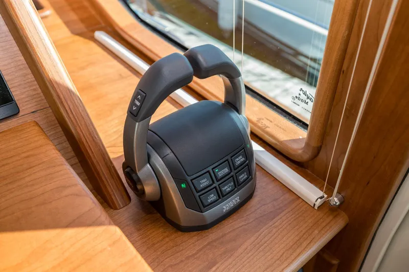 Slide: The Image of Throttle control panel on 2025 Sabre 43 Salon Express yacht, featuring advanced navigation buttons. - 33