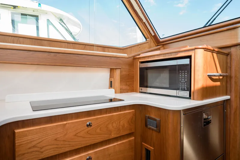 Slide: The Image of Modern kitchen interior of 2025 Sabre 43 Salon Express yacht with microwave and sleek design. - 35