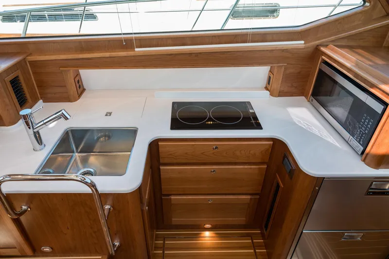 Slide: The Image of Modern kitchen in 2025 Sabre 43 Salon Express yacht with stove, sink, and microwave. - 36