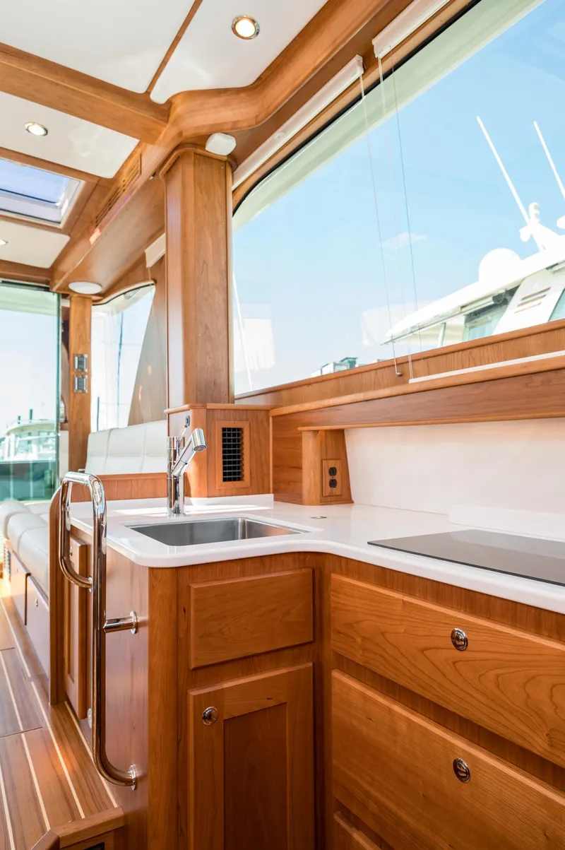 Slide: The Image of Luxurious interior of 2025 Sabre 43 Salon Express yacht with wooden cabinetry and modern amenities. - 37