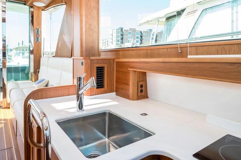 Slide: The Image of Luxurious interior of 2025 Sabre 43 Salon Express yacht with modern kitchen and seating area. - 38