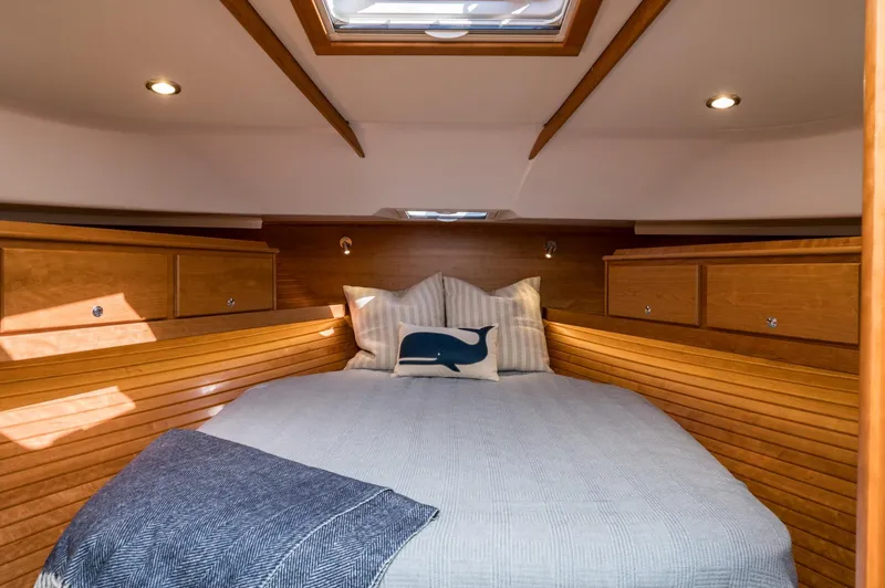 Slide: The Image of Luxurious cabin interior of 2025 Sabre 43 Salon Express with cozy bedding and wooden finish. - 47