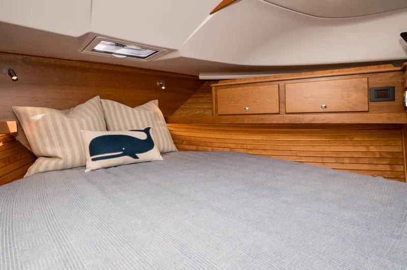Slide: The Image of Cozy cabin interior of 2025 Sabre 43 Salon Express with wooden accents and decorative pillows. - 48
