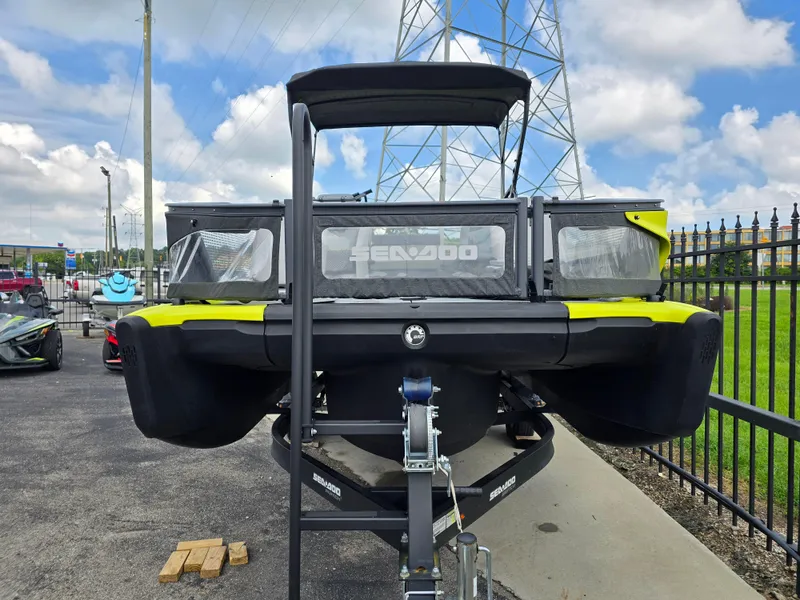 Slide: The Image of 2023 Sea-Doo Switch Sport 21 on trailer, parked outdoors under a cloudy sky. - 3