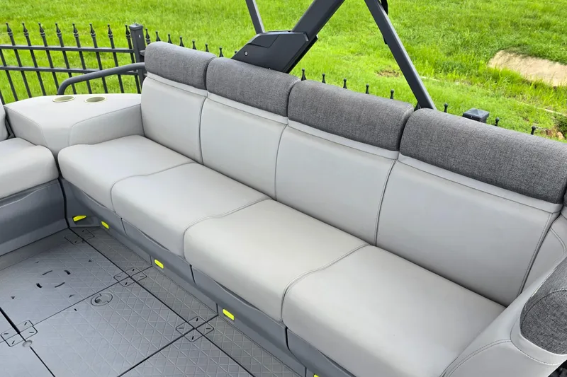 Slide: The Image of 2023 Sea-Doo Switch Sport 21 interior seating with gray upholstery and cup holders. - 8