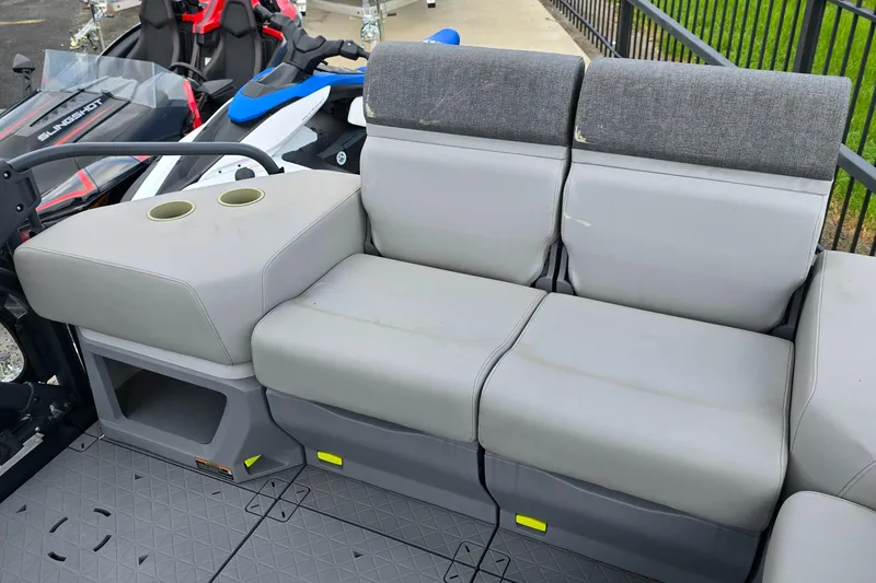 Slide: The Image of 2023 Sea-Doo Switch Sport 21 seating area with cup holders and gray upholstery. - 9
