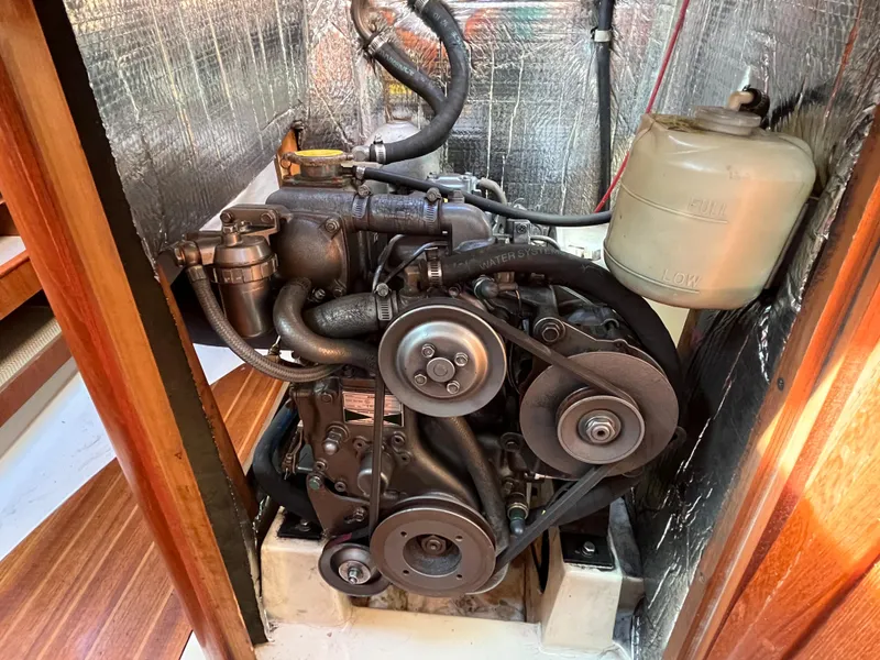 Slide: The Image of Engine compartment of a 1992 Hunter 30-2 sailboat, featuring mechanical components and insulation. - 10