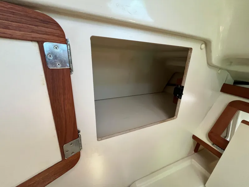Slide: The Image of Interior storage compartment of a 1992 Hunter 30-2 sailboat, featuring wooden trim. - 15