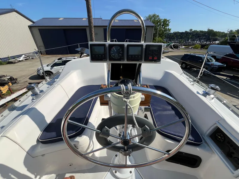 Slide: The Image of 1992 Hunter 30-2 sailboat cockpit with steering wheel and navigation instruments. - 18