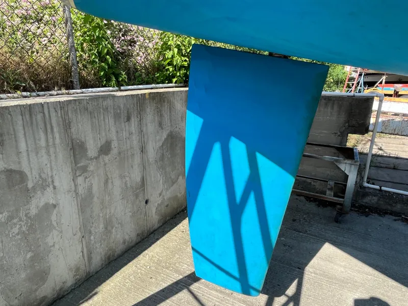 Slide: The Image of Blue keel of a 1992 Hunter 30-2 sailboat in a dry dock setting. - 38