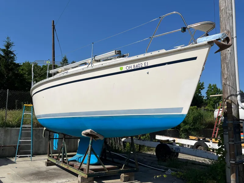 The Image of 1992 Hunter 30-2 sailboat on dry dock, blue hull, clear sky background. - 0