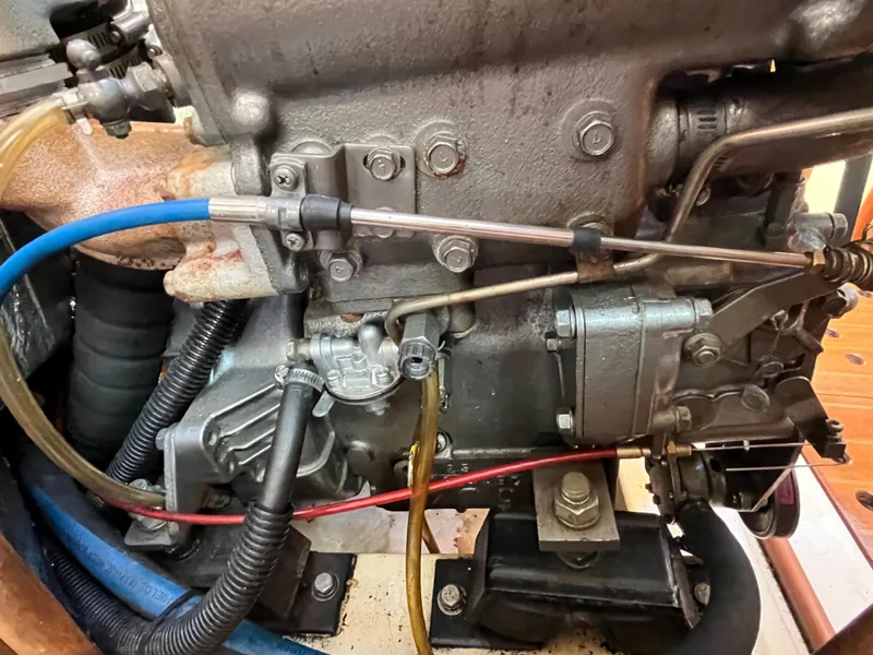 Slide: The Image of Close-up of a 1992 Hunter 30-2 engine with visible hoses and components. - 11