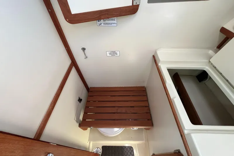 Slide: The Image of Interior of 1992 Hunter 30-2 sailboat bathroom with wooden accents and compact design. - 13