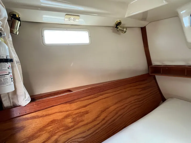 Slide: The Image of Interior cabin of a 1992 Hunter 30-2 sailboat with wood paneling and window. - 31