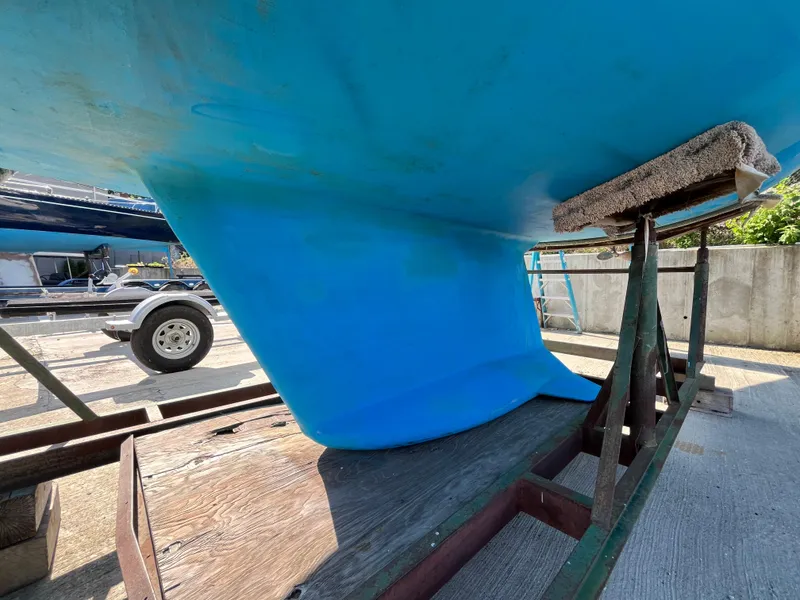 Slide: The Image of Blue hull of a 1992 Hunter 30-2 sailboat on a trailer in a boatyard. - 36