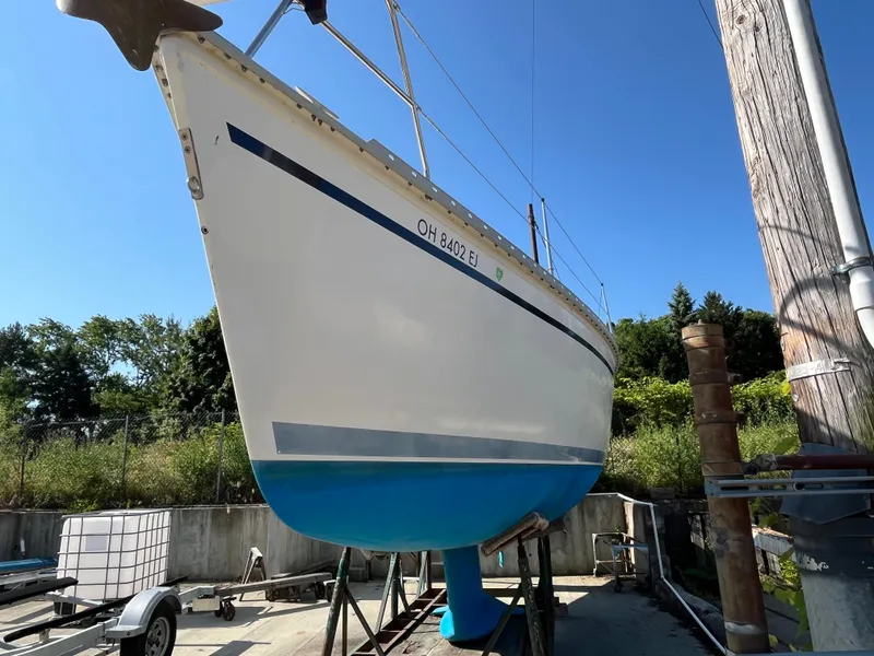 Slide: The Image of 1992 Hunter 30-2 sailboat on trailer, blue and white hull, outdoors. - 39