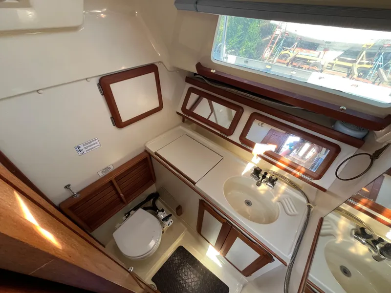 Slide: The Image of Interior of 1992 Hunter 30-2 sailboat bathroom with sink, toilet, and wooden accents. - 7