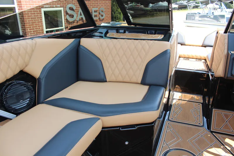 Slide: The Image of 2024 Tigé 24RZX boat interior with tan and black seating, diamond stitching, and stylish flooring. - 11