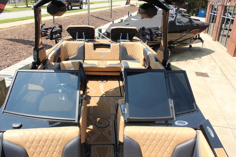 Slide: The Image of 2024 Tigé 24RZX boat interior with tan upholstery and sleek design. - 14