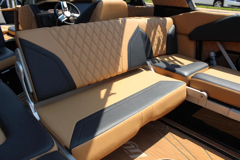 Slide: The Image of 2024 Tigé 24RZX boat interior with tan and black leather seating. - 15