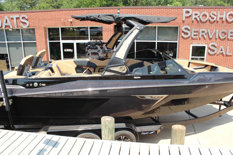 Slide: The Image of 2024 Tigé 24RZX boat displayed at dealership, featuring sleek black design and modern amenities. - 5