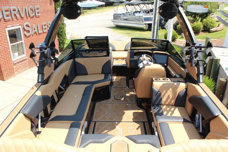Slide: The Image of 2024 Tigé 24RZX boat interior with luxurious tan and black seating, advanced dashboard. - 6