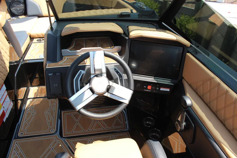 Slide: The Image of 2024 Tigé 24RZX boat interior with modern steering wheel and dashboard. - 7