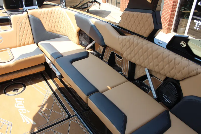 Slide: The Image of 2024 Tigé 24RZX boat interior with tan and black quilted seating. - 9