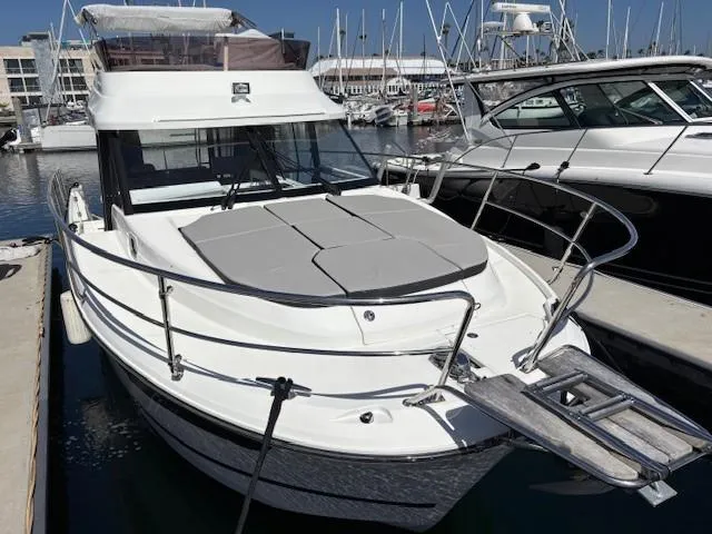 The Image of 2020 Jeanneau NC 1095 Fly yacht docked at marina, featuring spacious deck and modern design. - 0