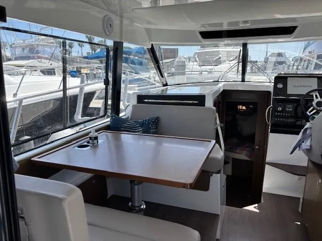 Slide: The Image of Interior of 2020 Jeanneau NC 1095 Fly boat with dining area and navigation equipment. - 11