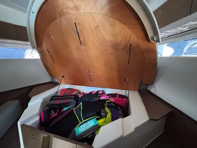 Slide: The Image of Storage compartment in 2020 Jeanneau NC 1095 Fly boat, containing colorful life jackets. - 21