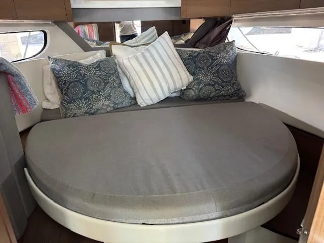 Slide: The Image of Cozy cabin interior of 2020 Jeanneau NC 1095 Fly with round bed and decorative pillows. - 23