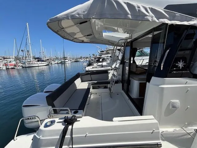 Slide: The Image of 2020 Jeanneau NC 1095 Fly yacht docked, featuring spacious deck and Yamaha engines. - 28