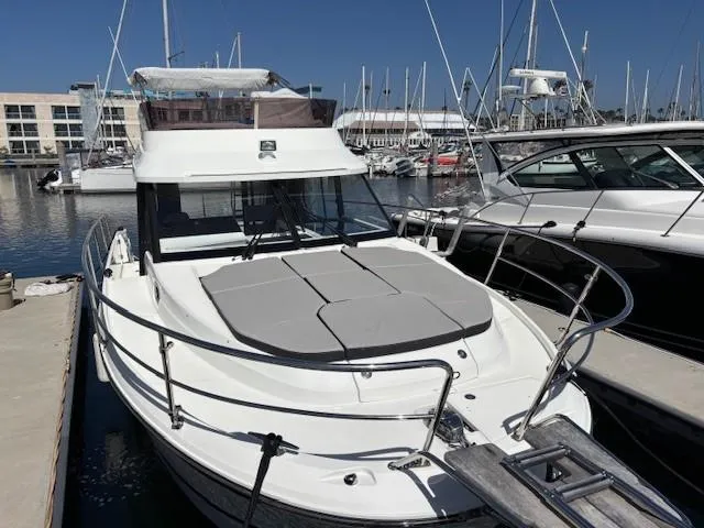 Slide: The Image of 2020 Jeanneau NC 1095 Fly yacht docked at marina, featuring spacious deck and modern design. - 3