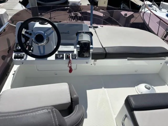 Slide: The Image of 2020 Jeanneau NC 1095 Fly helm with steering wheel and controls, featuring Yamaha equipment. - 37