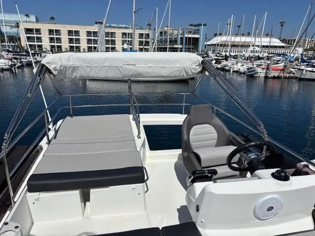 Slide: The Image of Flybridge of 2020 Jeanneau NC 1095 Fly yacht in marina setting. - 42