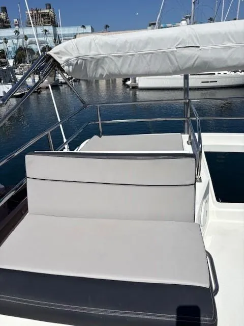 Slide: The Image of 2020 Jeanneau NC 1095 Flybridge with cushioned seating, docked in a marina. - 45