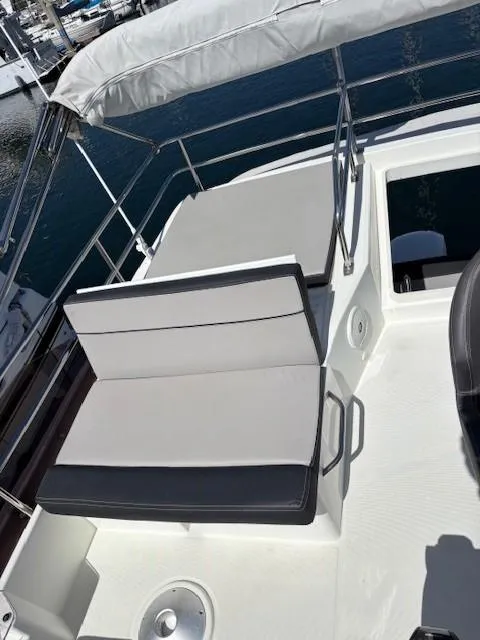 Slide: The Image of Flybridge seating on 2020 Jeanneau NC 1095 Fly yacht, featuring cushioned seats and railing. - 47