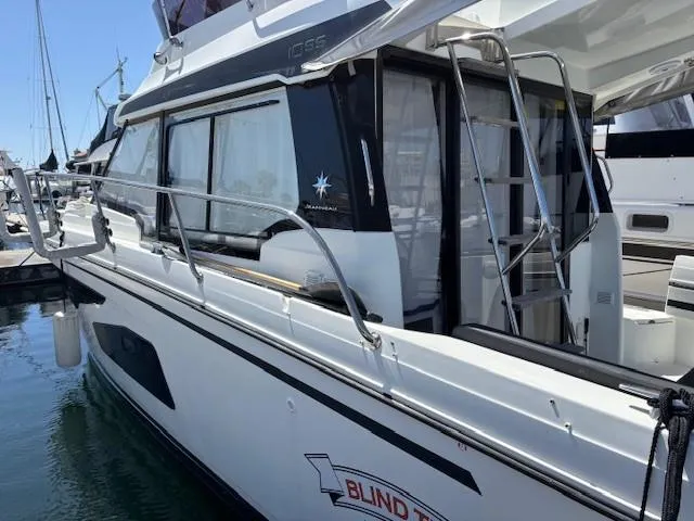 Slide: The Image of 2020 Jeanneau NC 1095 Fly yacht docked at marina, side view. - 48