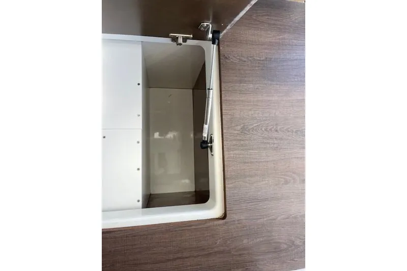 Slide: The Image of Open storage compartment on Jeanneau NC 1095 Fly 2020 boat with wood finish. - 57