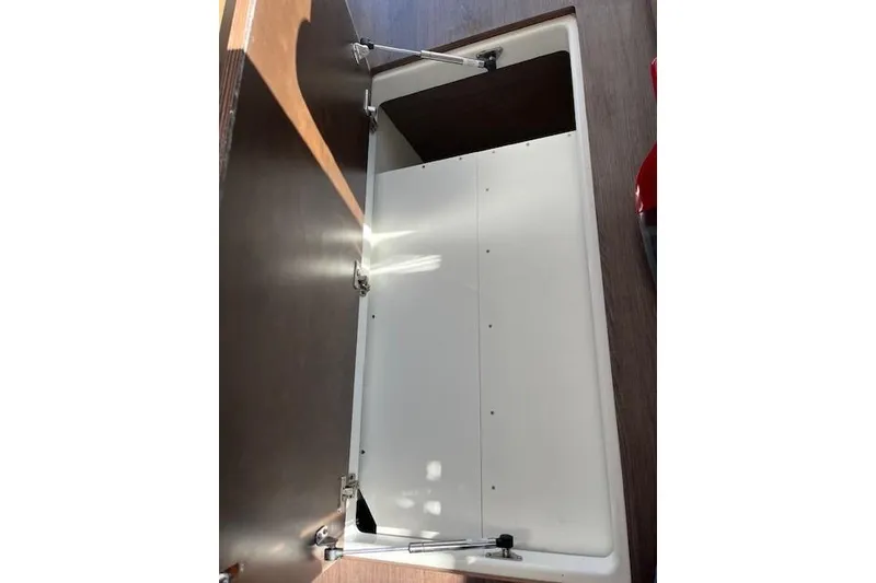Slide: The Image of Open storage compartment on 2020 Jeanneau NC 1095 Fly boat interior. - 58