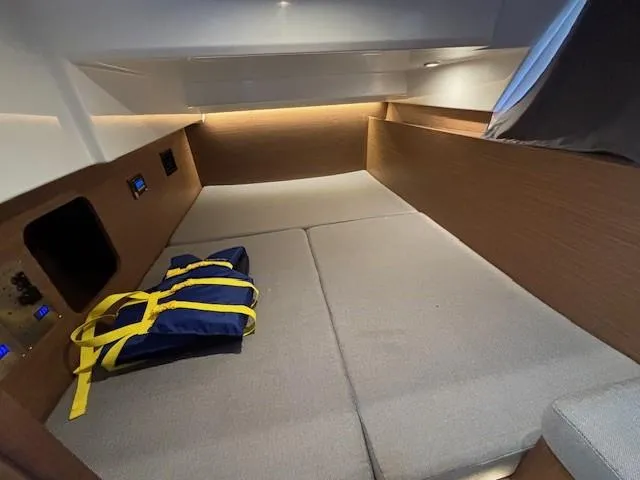 Slide: The Image of Interior cabin of 2020 Jeanneau NC 1095 Fly with life jacket on bed. - 7