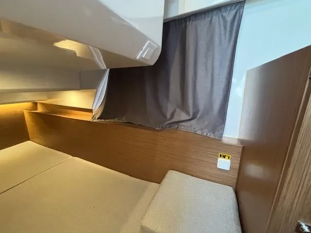 Slide: The Image of Interior cabin of 2020 Jeanneau NC 1095 Fly with wood paneling and cozy bedding. - 8
