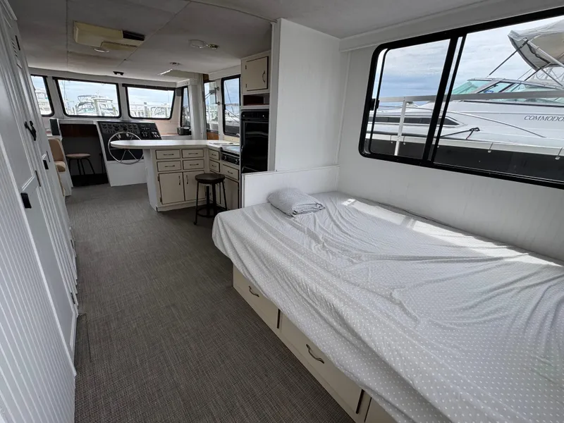 Slide: The Image of Interior of a 1993 Gibson 37 Sport Series boat with bed and helm. - 10