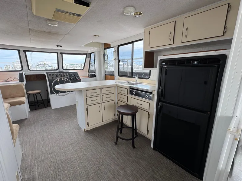Slide: The Image of Interior of a 1993 Gibson 37 Sport Series boat with kitchen and helm. - 11
